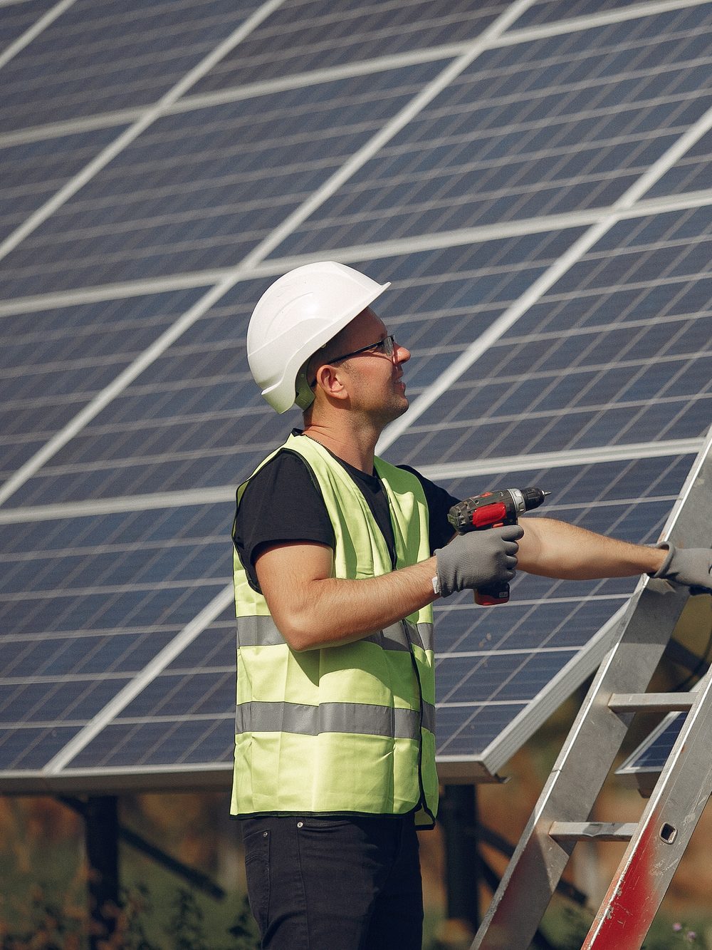 SKYLAVA engineer in hard hat and hi-vis fitting a solar panel array